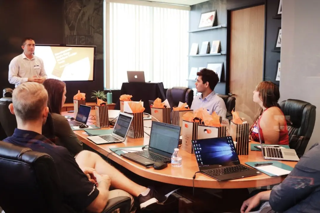 An executive team scoping a corporate brand film around a strategy table — the leadership and investor communications ArcaneWiz produces at the top of the AI corporate video price band