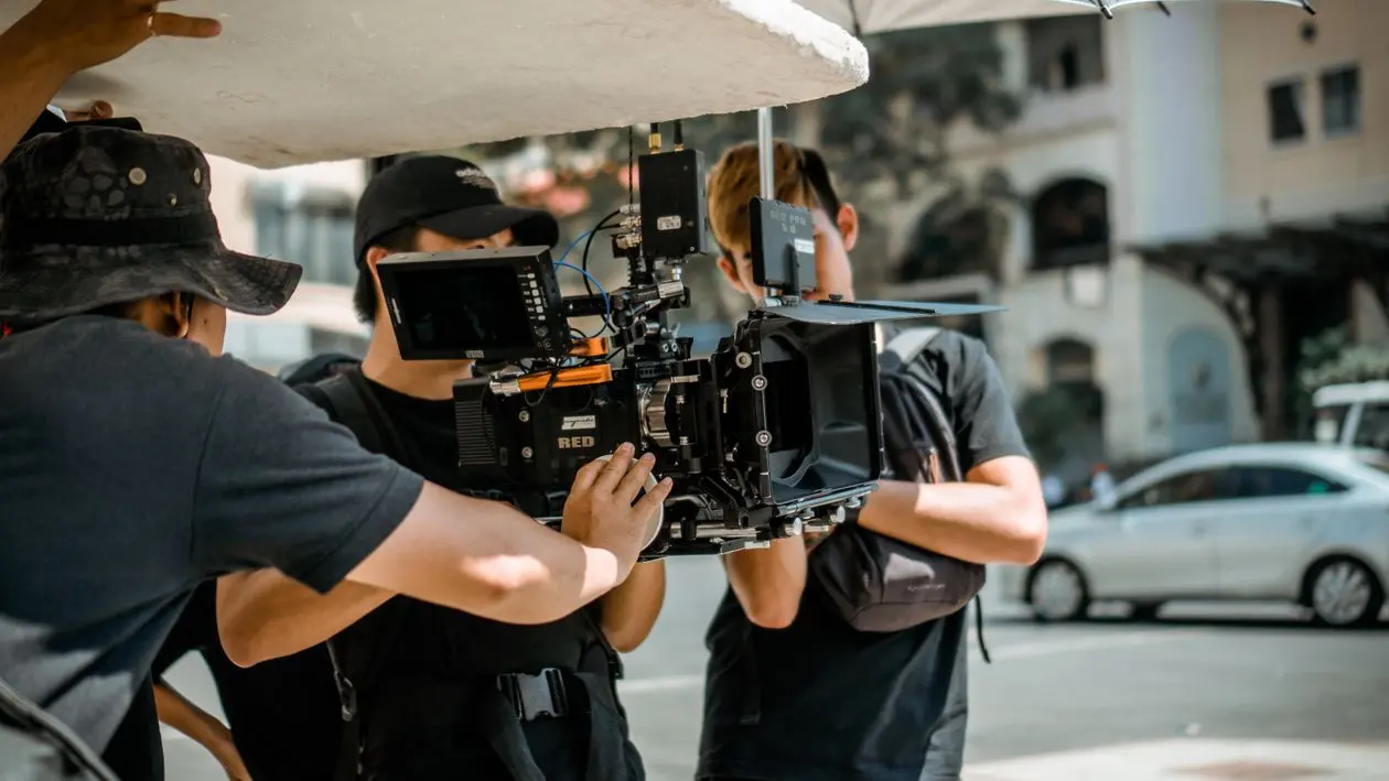 Senior film crew with a cinema camera — the traditional craft layer behind an AI-produced SaaS launch video