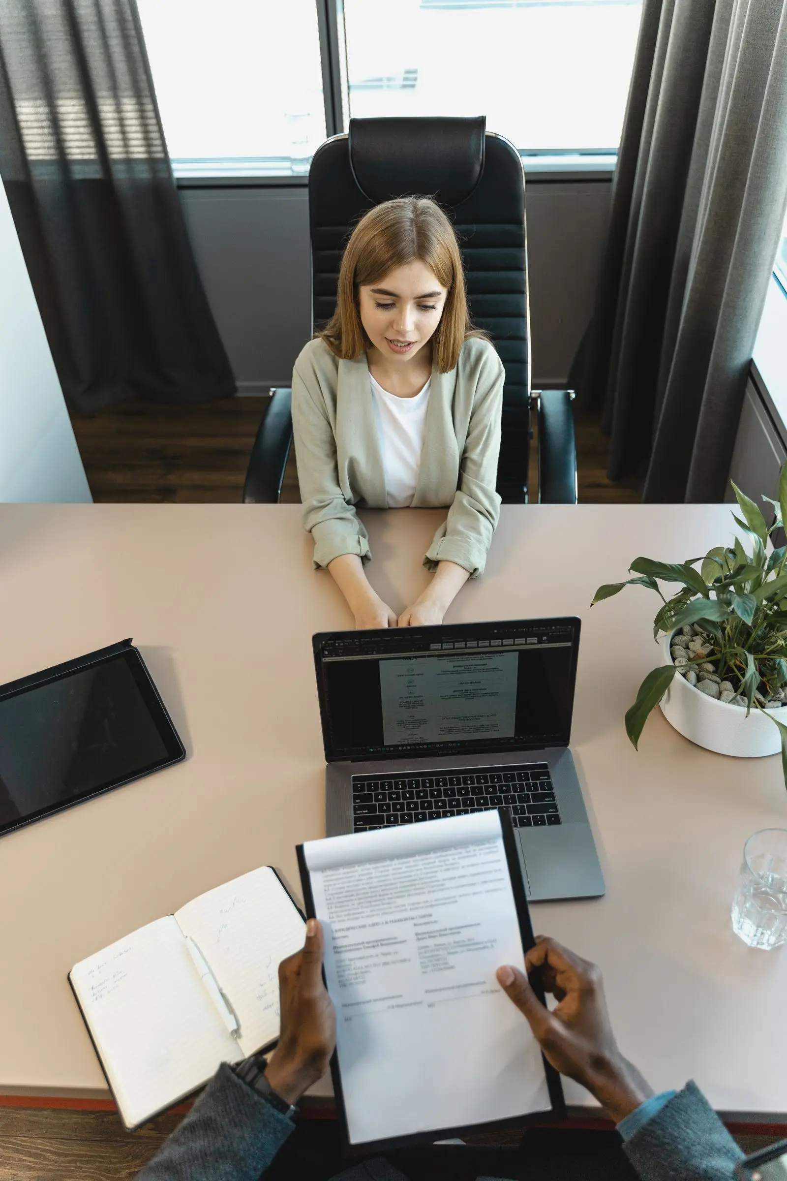 AI recruitment video — candidate and hiring manager meeting across a desk, careers-page and hiring-funnel film still by ArcaneWiz