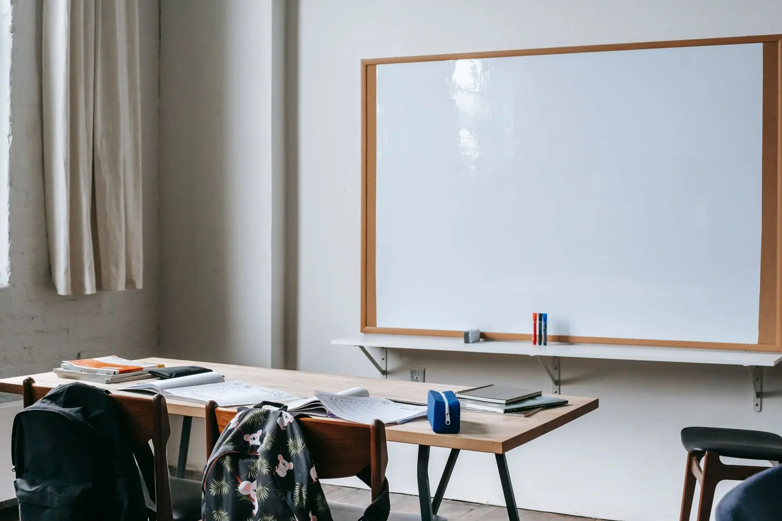 Modern classroom with whiteboard and desks ready for instruction &mdash; academic and institutional education setting