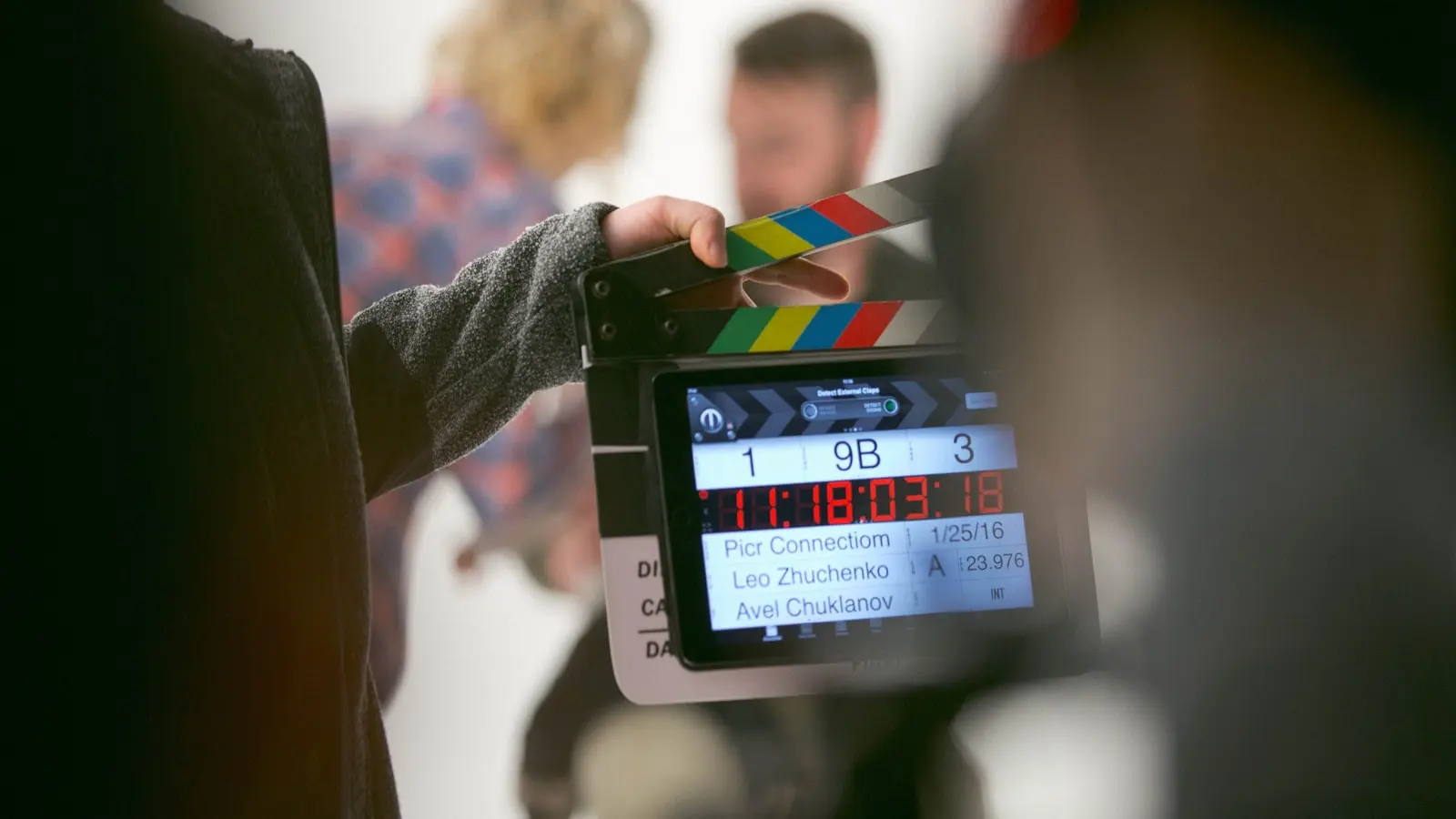 A film clapperboard on a live set — the cinematic production craft, led by Daniel Atzil, that Arcanewiz layers over AI tools rather than selling a self-serve subscription.