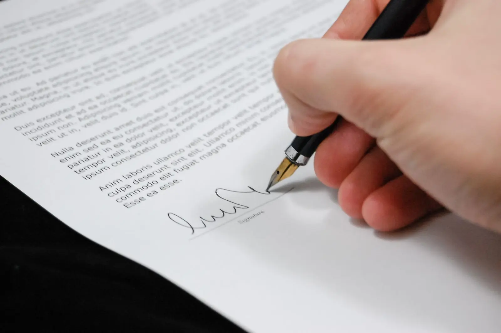 A customer signing a written consent and likeness release form before an AI-assisted testimonial video production